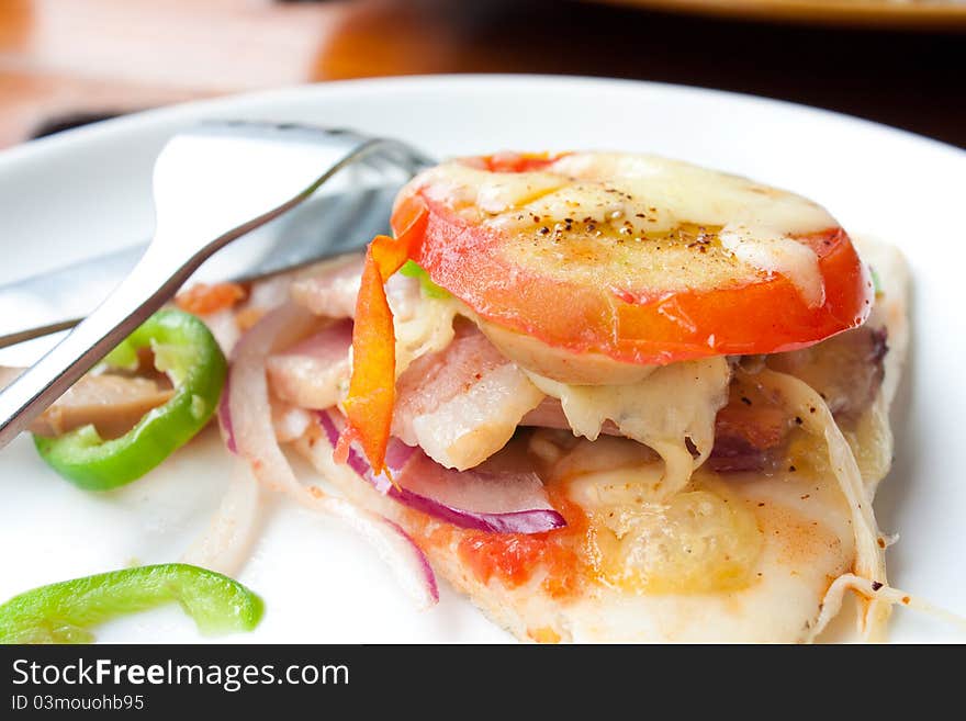 A slice of Pizza with tomato and fork