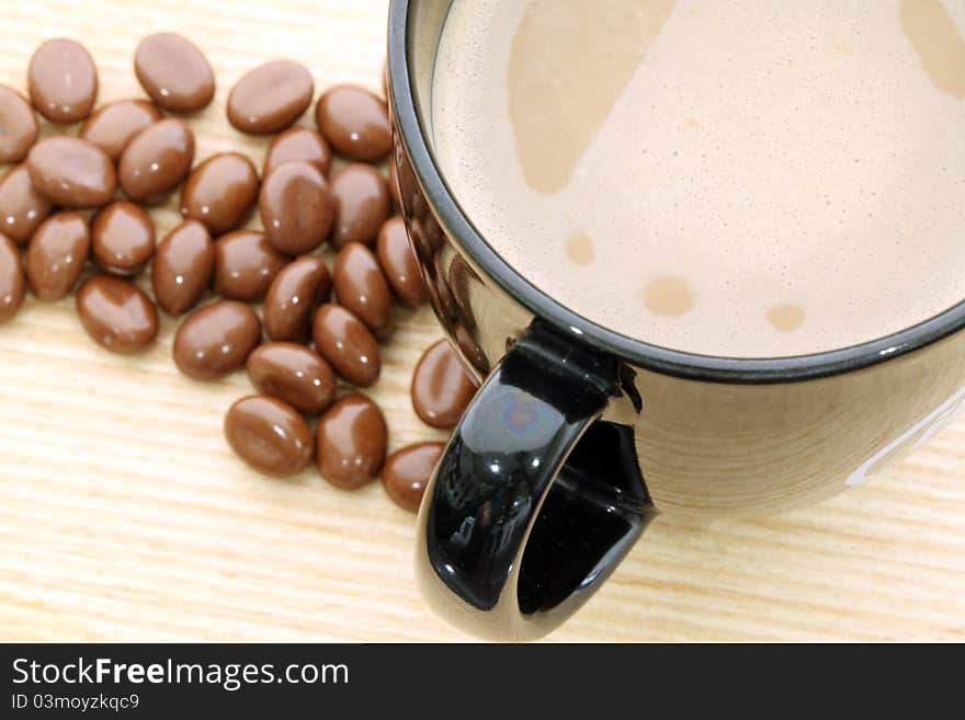 Cup of coffee on wood background.