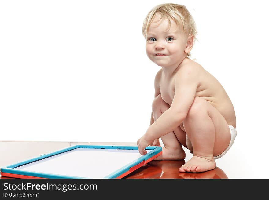 Two years old boy with draw desk on the table. Two years old boy with draw desk on the table