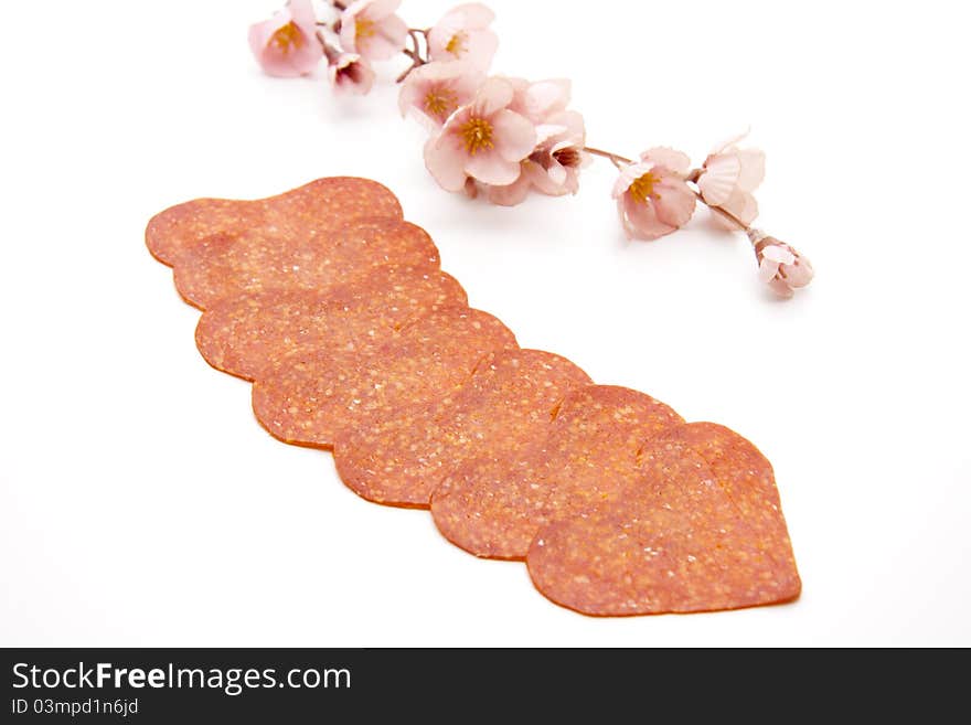 Salami in heart form with flowering branch