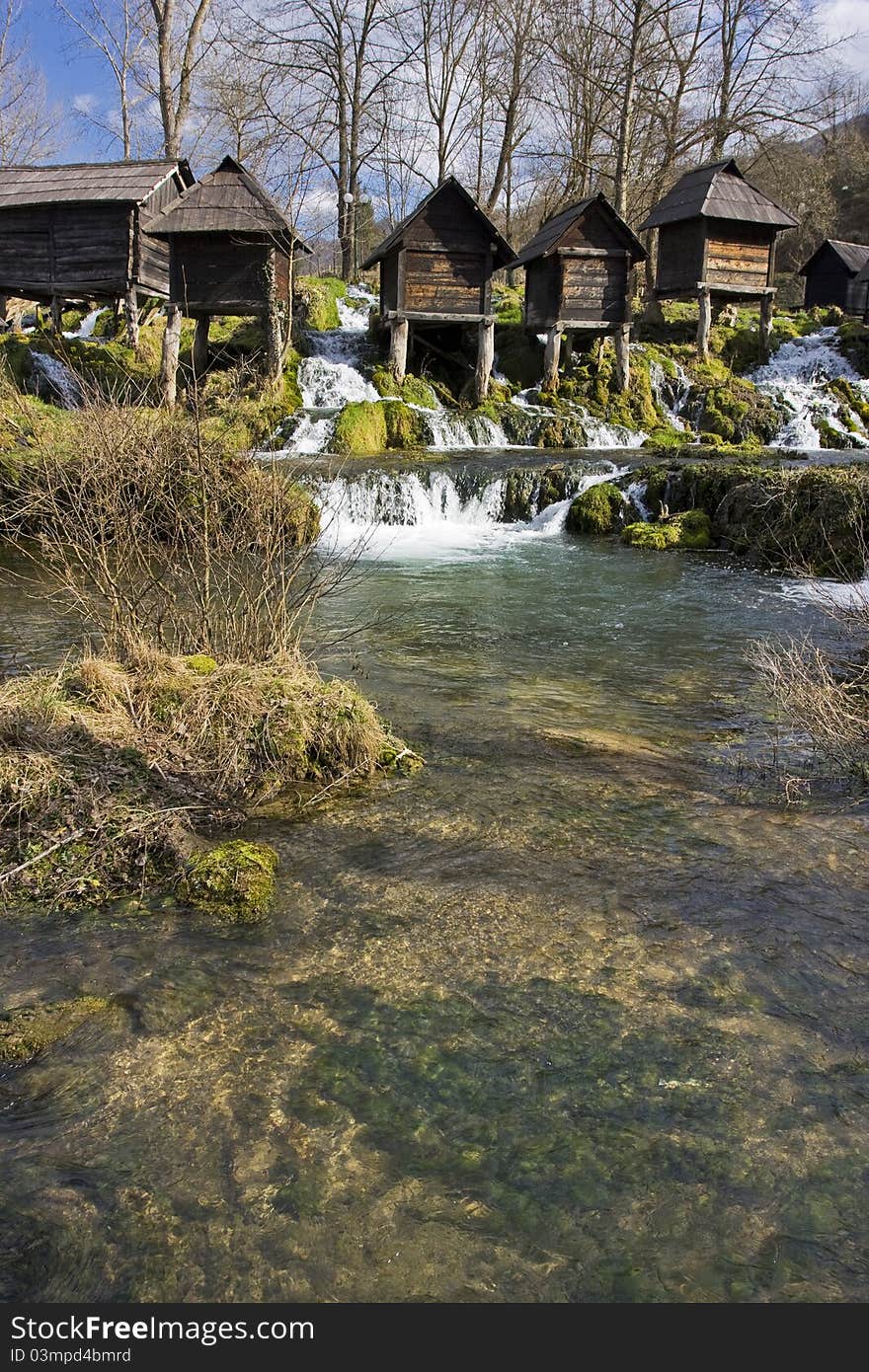 Old wooden watermills on the river. Old wooden watermills on the river