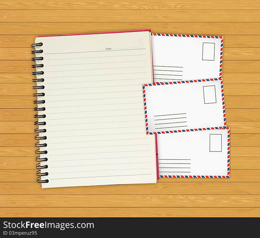 Note book with Old envelopes on wooden background for design-works