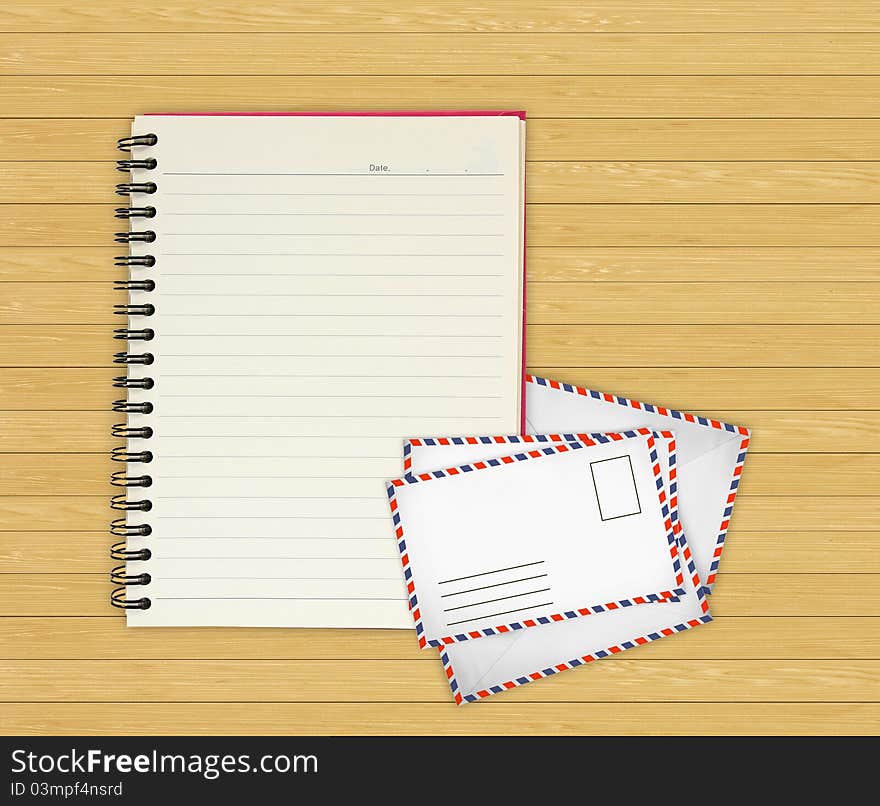 Note book with Old envelopes on wooden