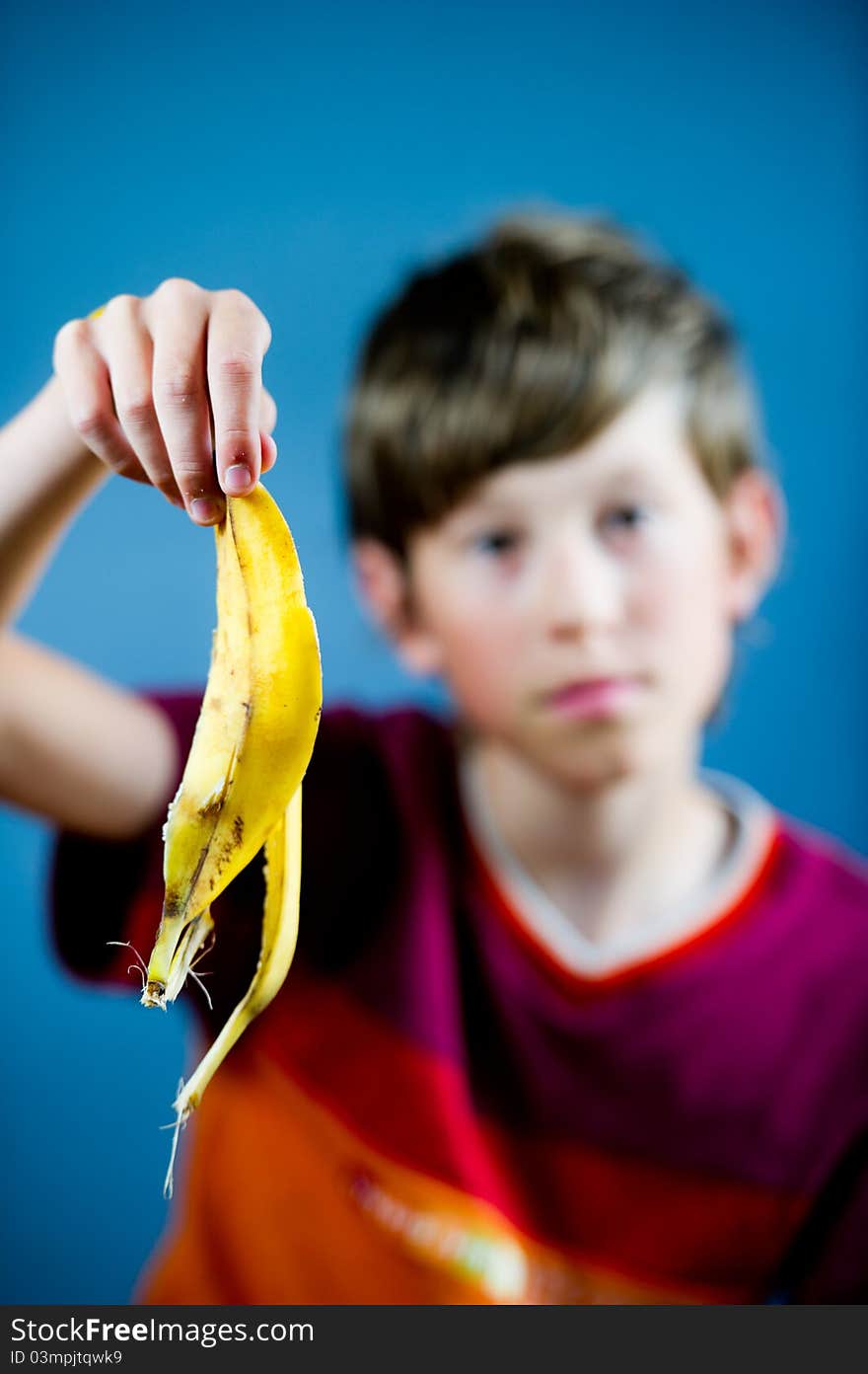 Teenager holding a banana peel