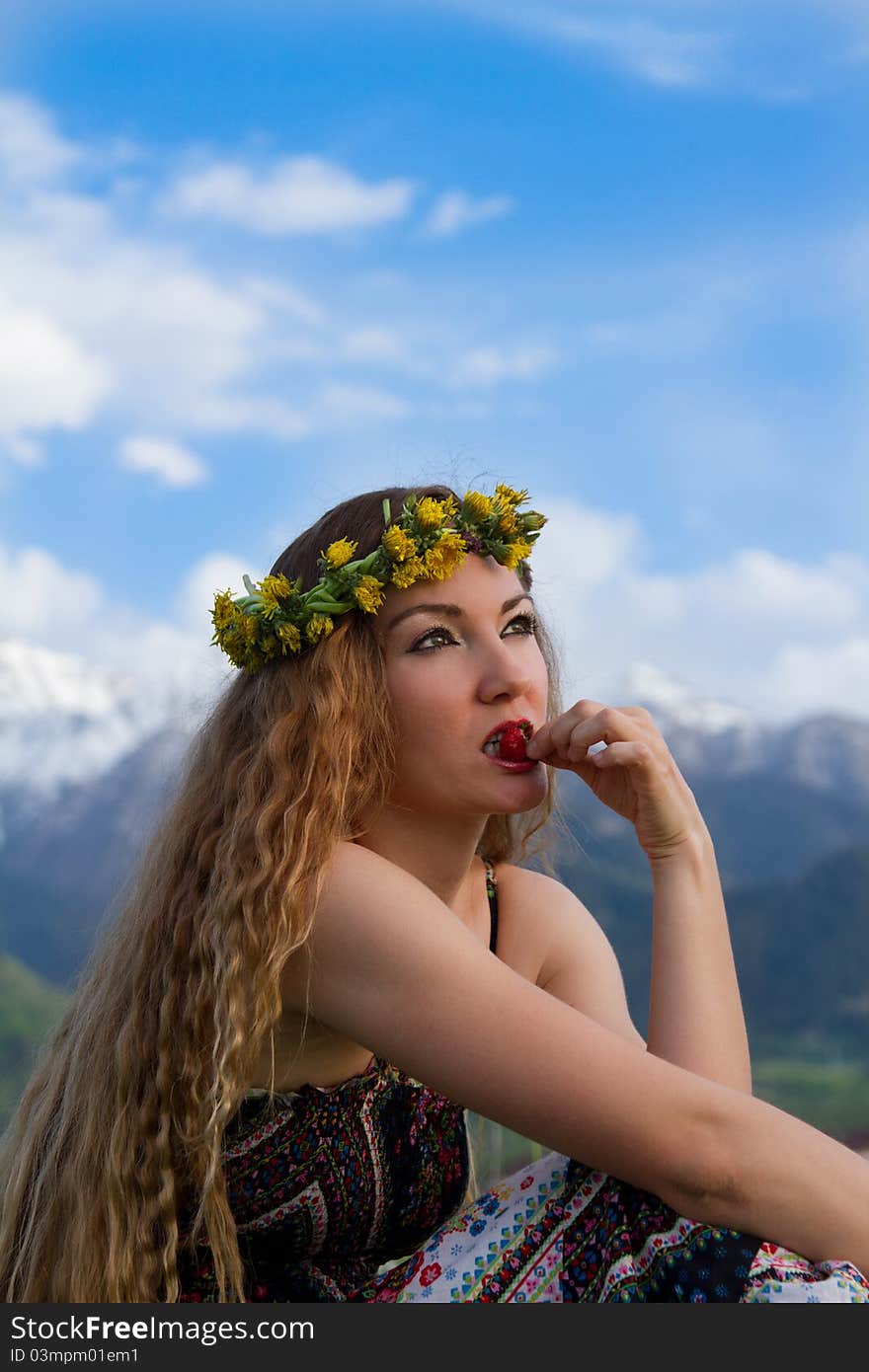 Girl Eating Strawberries On Blue Sky Background