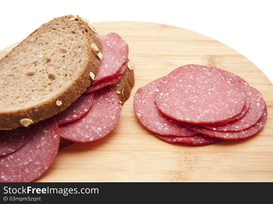 Bread with salamis onto wood plates