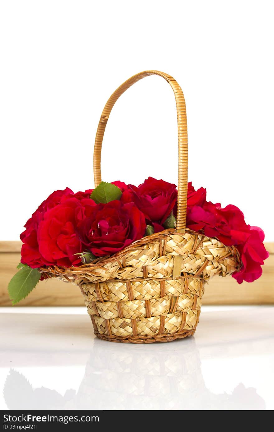 Beautiful red roses in a wicker basket. Isolated. Beautiful red roses in a wicker basket. Isolated