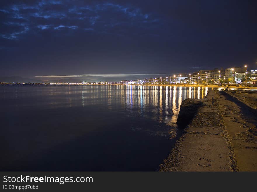 The beach of El Arenal on the balearic island of Majorca in Spain by twilight. You can also see the city of Palma in the distance. The beach of El Arenal on the balearic island of Majorca in Spain by twilight. You can also see the city of Palma in the distance.