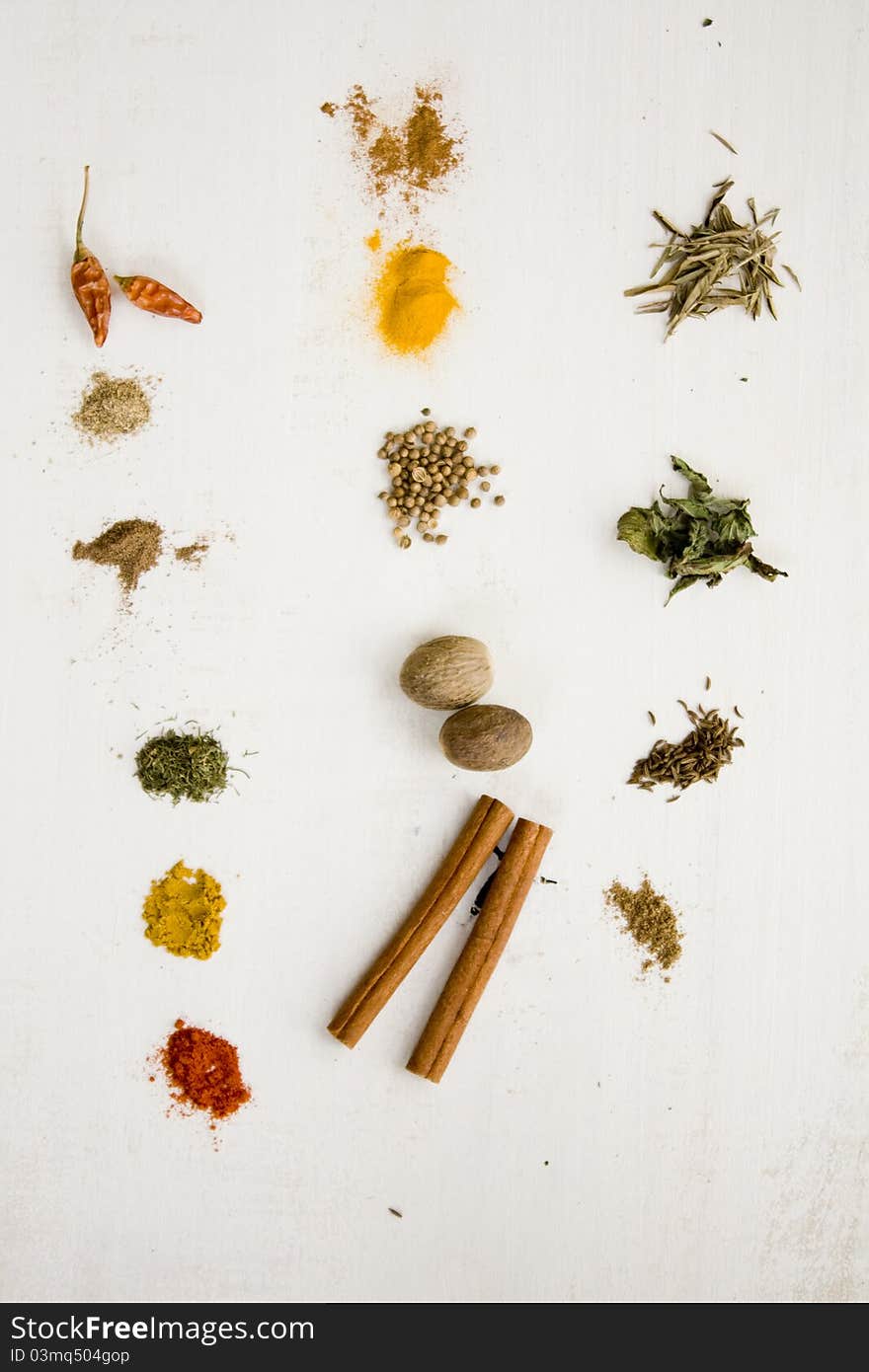 Many different colorful spices on white surface