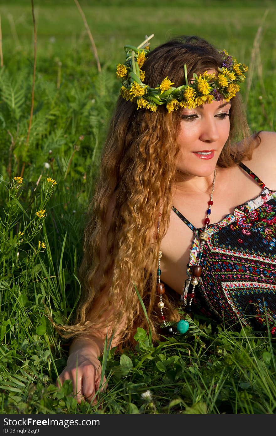 Very beautiful girl in the wreaths of flowers