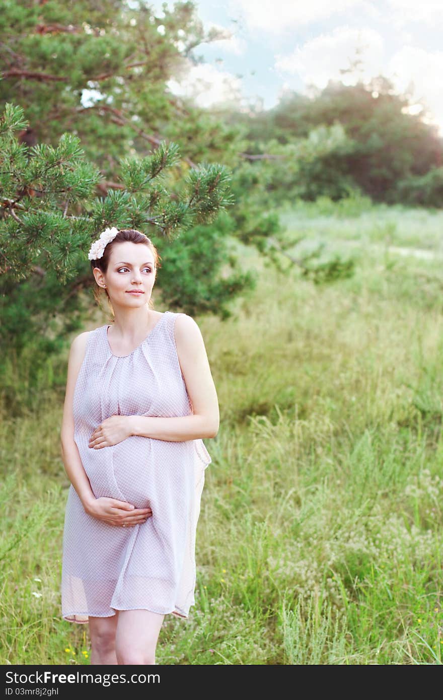 Beautiful pregnant woman relaxing outdoors