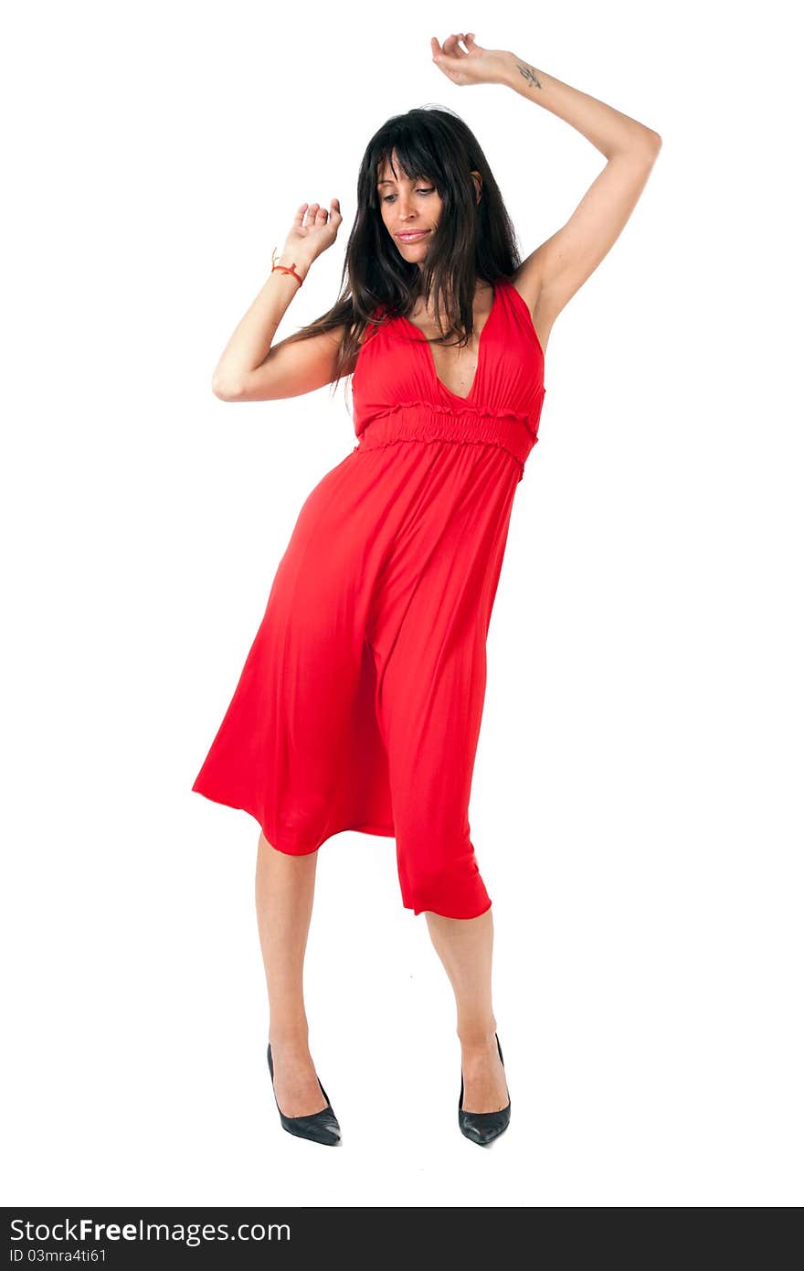 An attractive brunette on a red dress dancing. An attractive brunette on a red dress dancing