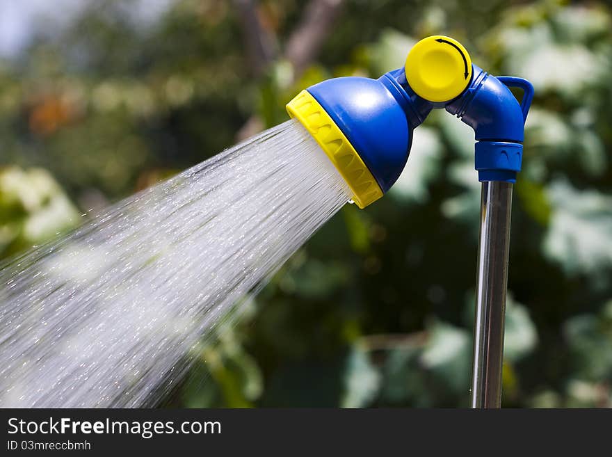 Open shower with running water, household items and equipment