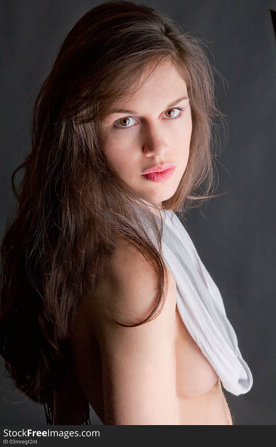 A portrait of a beautiful young woman, wearing a scarf in lieu of a shirt, and staring at the viewer. A portrait of a beautiful young woman, wearing a scarf in lieu of a shirt, and staring at the viewer