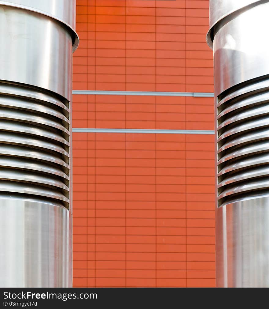 Metal pipe in front of the brickwork, an abstraction. Metal pipe in front of the brickwork, an abstraction