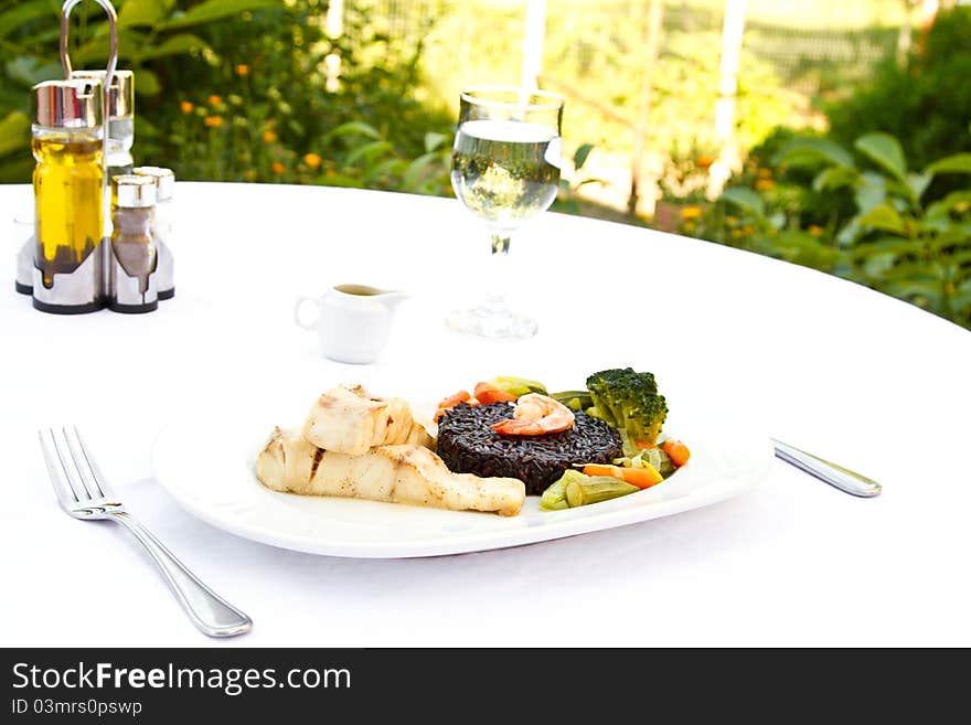 Fish with black rice, vegetables and prawn. Fish with black rice, vegetables and prawn