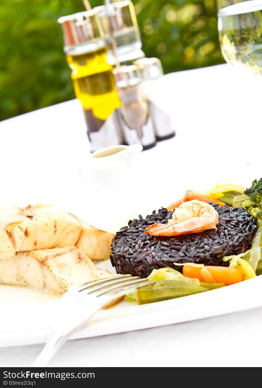 Fish with black rice, vegetables and prawn. Fish with black rice, vegetables and prawn