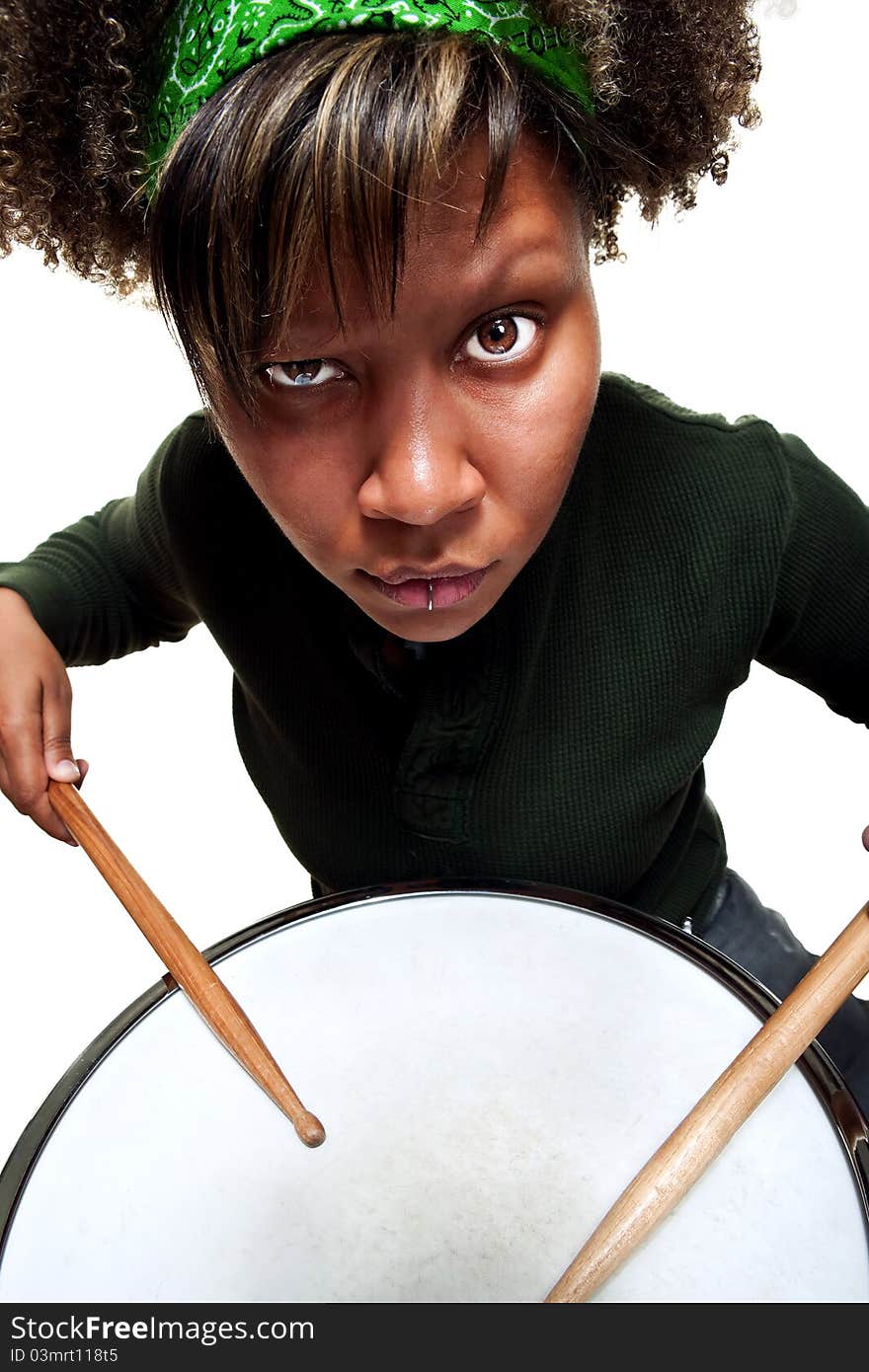 African girl in green sweater poses against white studeio background with an angry expression. African girl in green sweater poses against white studeio background with an angry expression.