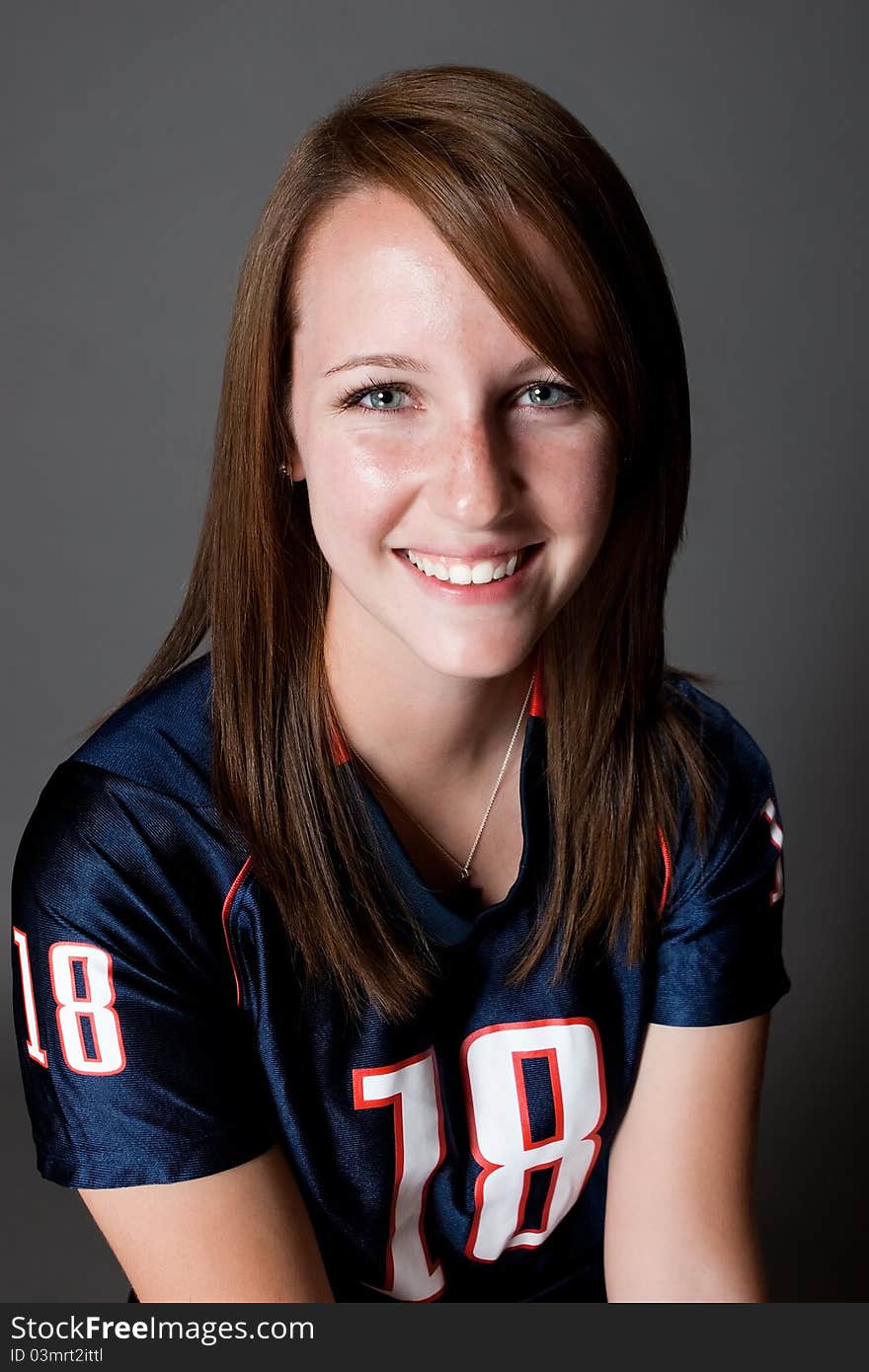 Caucasian female smiles for the camera with a happy expression in the studio. Caucasian female smiles for the camera with a happy expression in the studio.