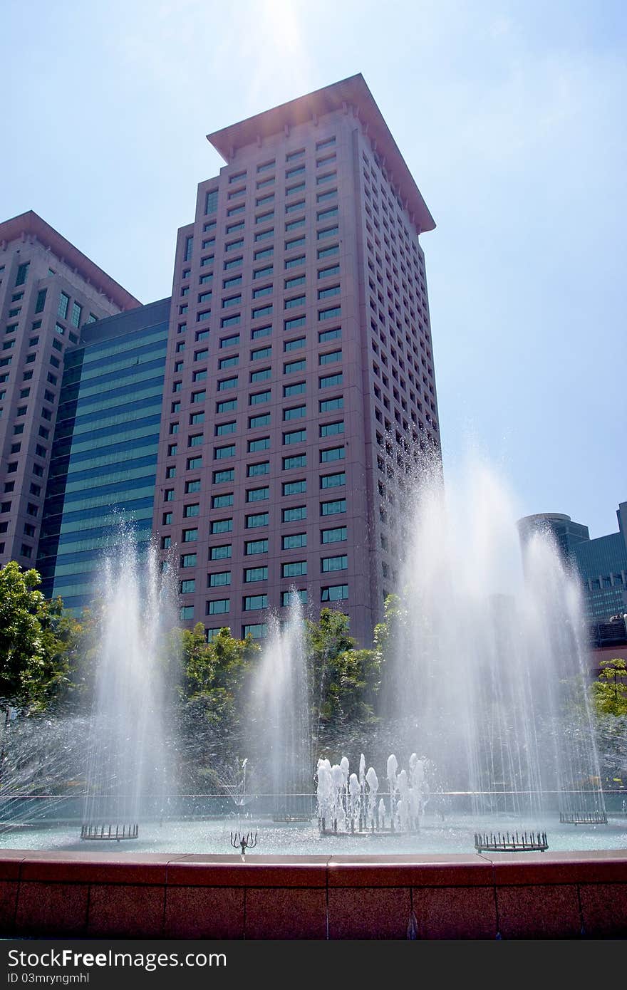 A fountain in a plaza of a city. A fountain in a plaza of a city