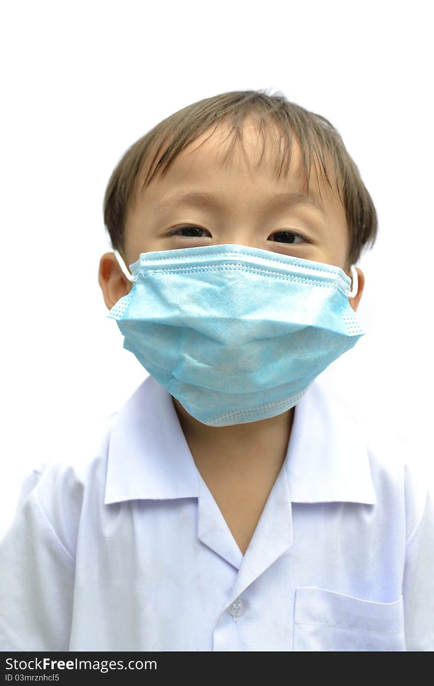 Cute asian young boy wearing disposable face mask on white background. Cute asian young boy wearing disposable face mask on white background.