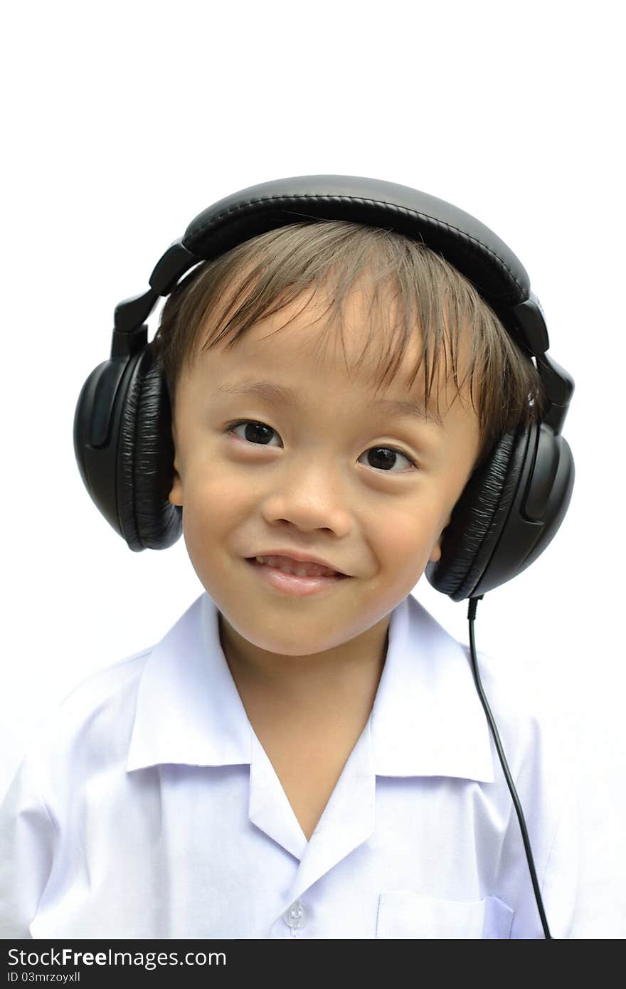 Cute asian young boy using headphone on white background. Cute asian young boy using headphone on white background.