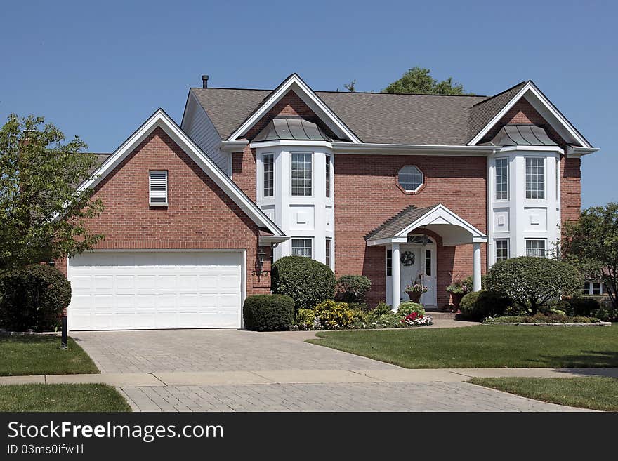 Brick home with columns and arched entry. Brick home with columns and arched entry