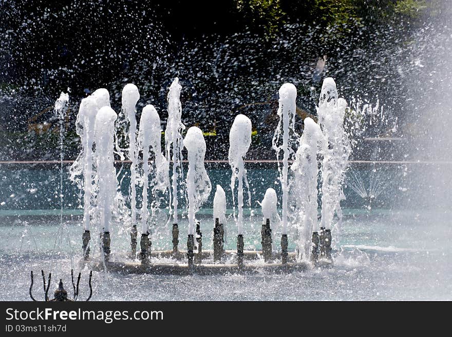 A fountain in a plaza of a city. A fountain in a plaza of a city