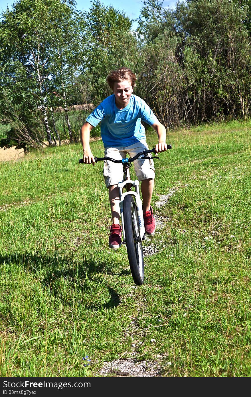 Boy racing with his bike in open