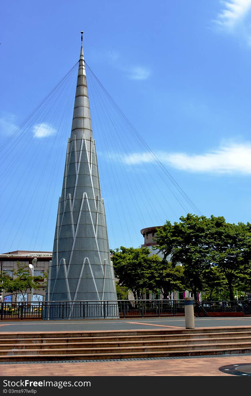 A tower of art statue in a plaza