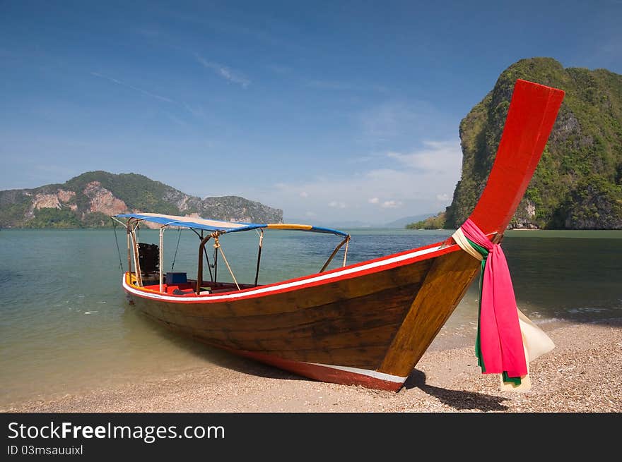 Boat on the beach with blu sky