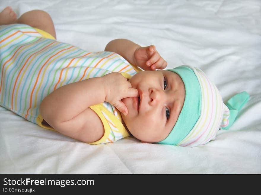 Beautiful baby lying on a bed