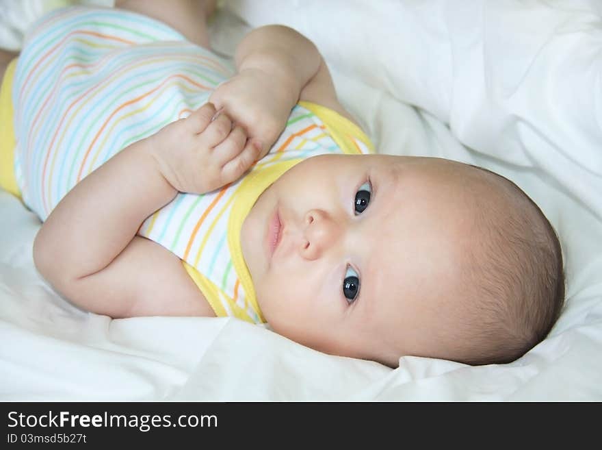 Beautiful baby lying on a bed