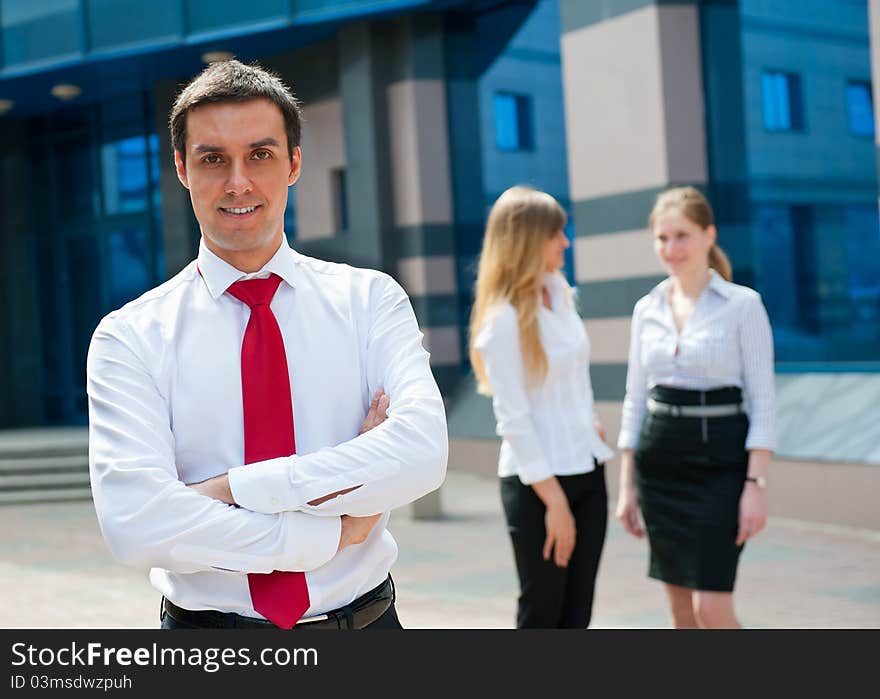 Business people in modern downtown. Cute businessman at foreground.