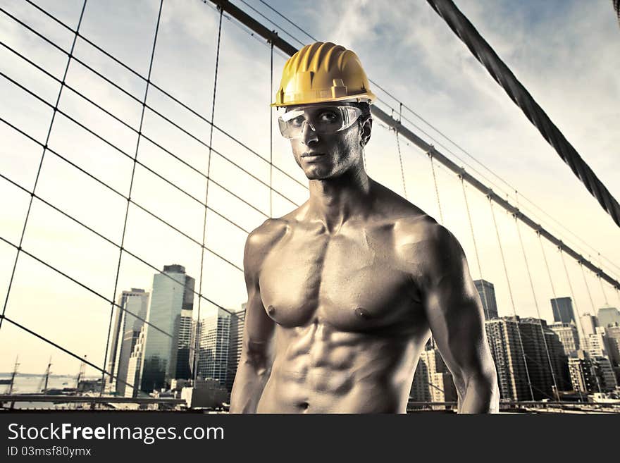 Handsome worker with cityscape in the background