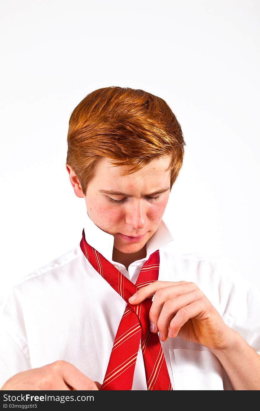 Teenager  binding his red tie