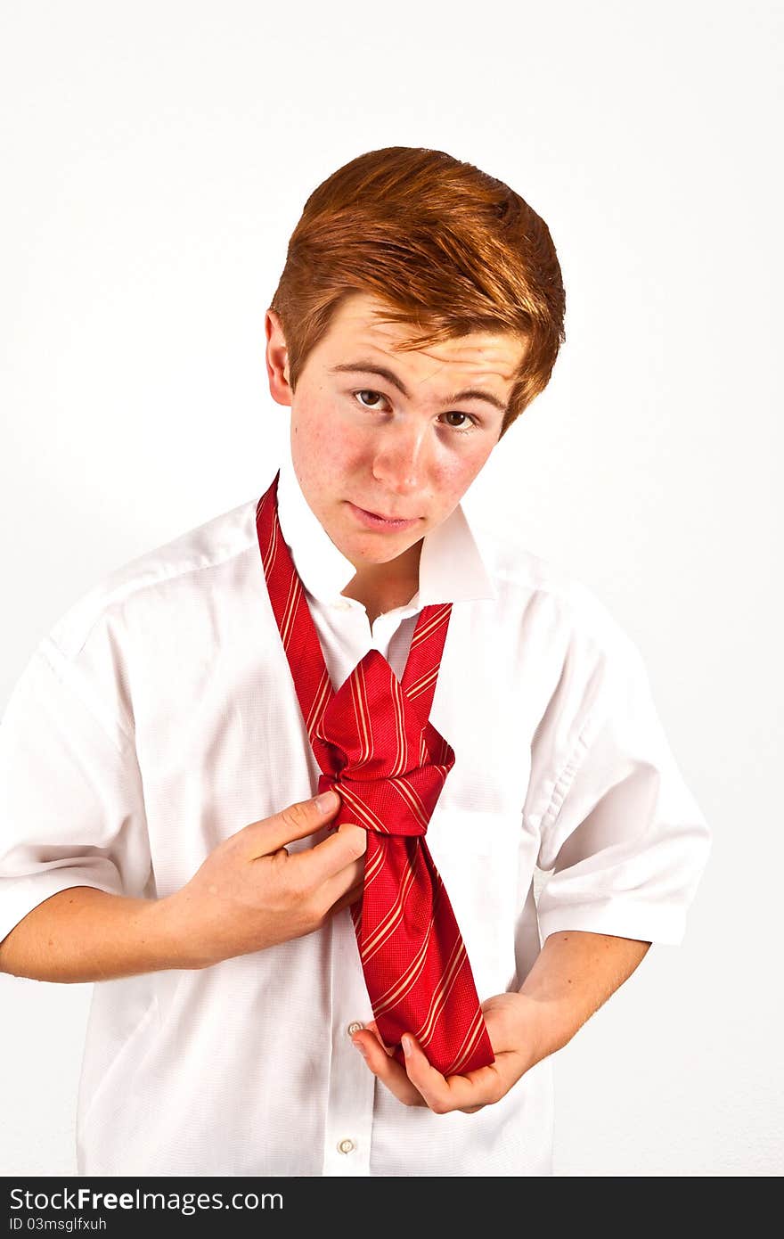 Teenager  binding his red tie