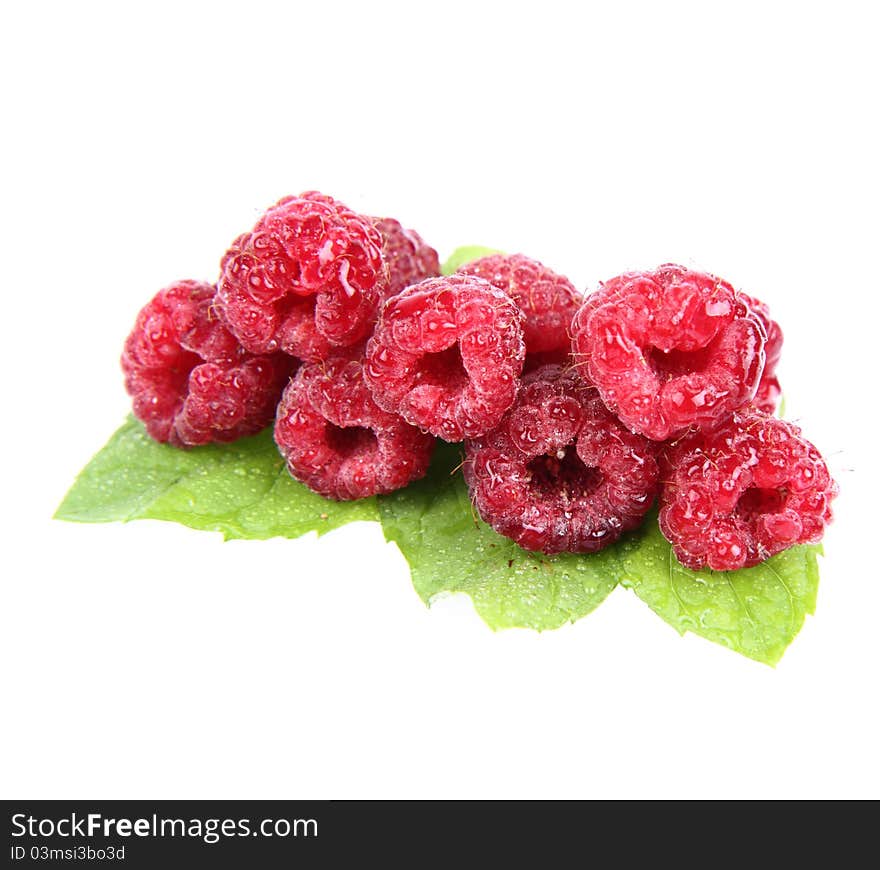 Raspberries: fruits on mint leaves on white background