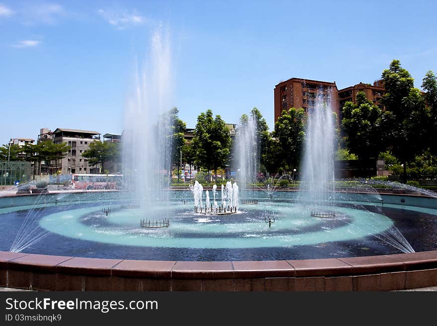 A fountain in a plaza of a city. A fountain in a plaza of a city