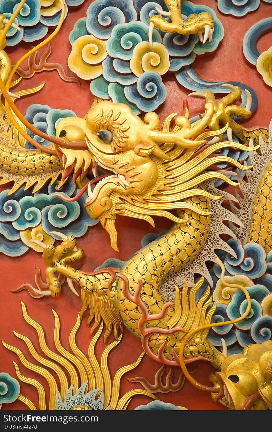 Golden dragon sculpture on Chinese temple wall