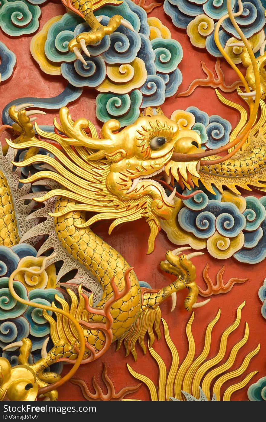 Golden dragon sculpture on Chinese temple wall