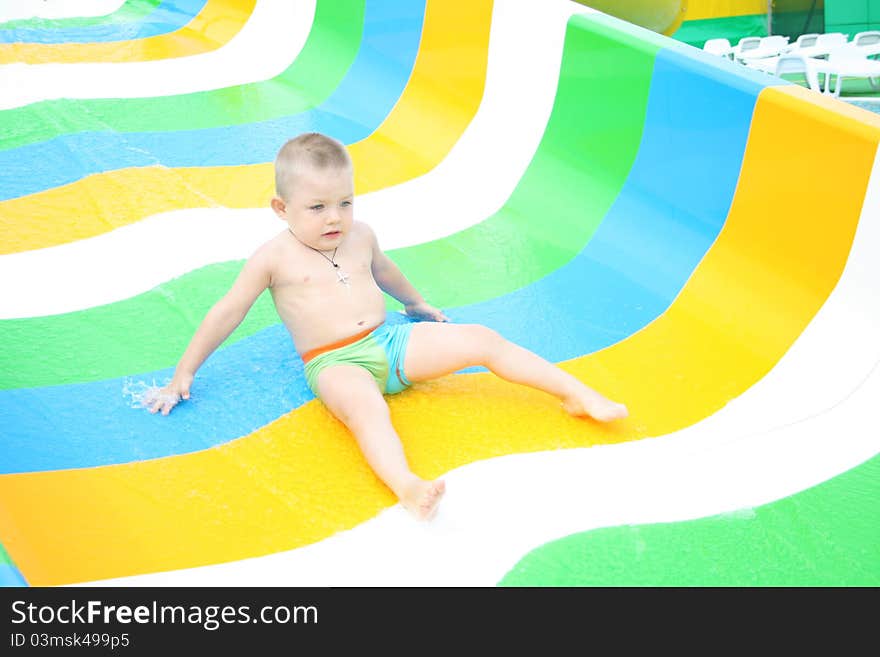 Baby boy coming down the waterslide. Baby boy coming down the waterslide