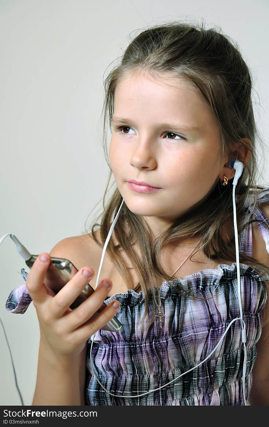 Child enjoying christian music through headphones.