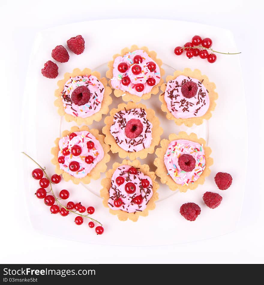 Tartlets with whipped cream, fruits and sprinkles - raspberries and redcurrants