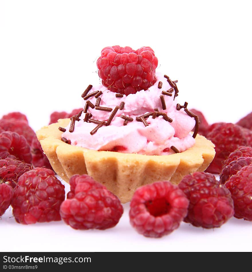 Tartlet with whipped cream and raspberries on a white background