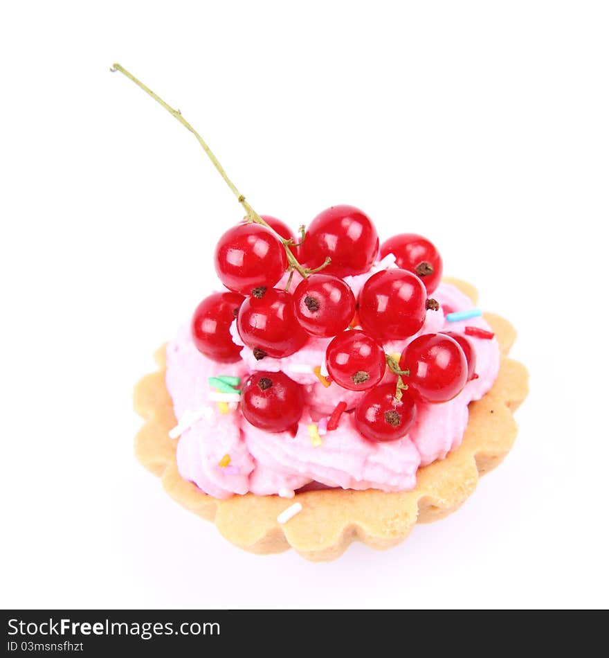 Tartlet with whipped cream, red currants and sprinkles on a white background