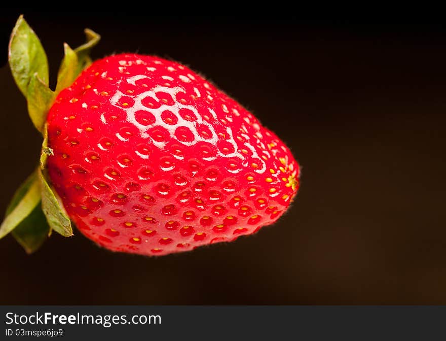 A red strawberry with leaves