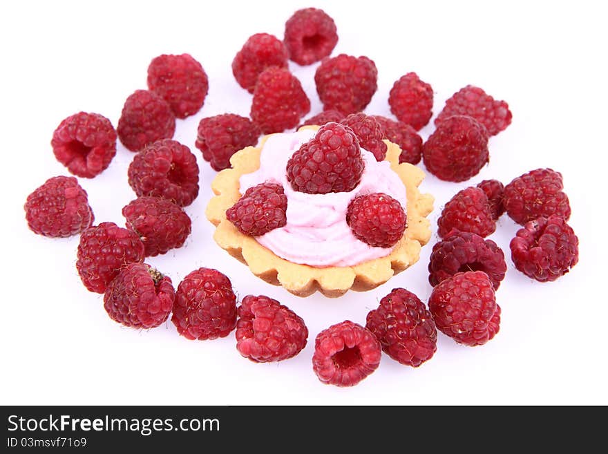 Tartlet with whipped cream and raspberries on a white background