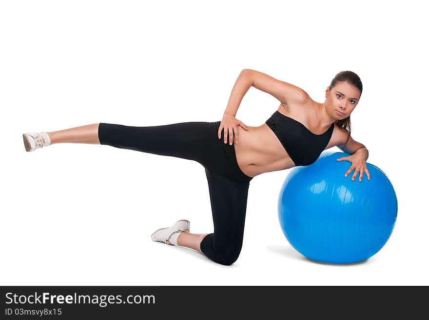 Portrait of strong girl excersicing with fitball in gym