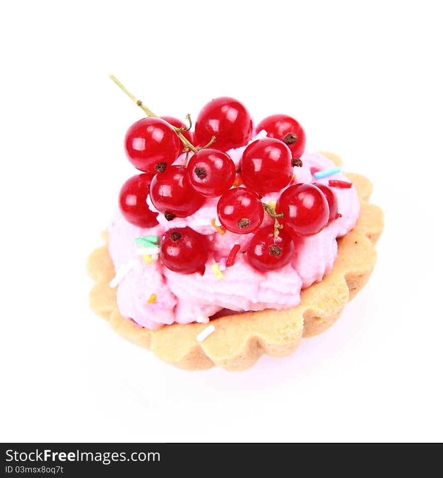 Tartlet with whipped cream, red currants and sprinkles on a white background